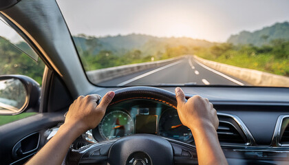 driving car on highway, close up of hands on steering wheel 