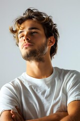 Fototapeta premium Portrait of Young Man with Arms Crossed Looking Up