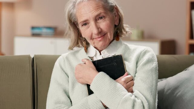 Sofa, hug and senior woman with frame for memory, remembrance or reflection at home. Smile, relax and elderly female person with dementia embracing picture for love nostalgia, souvenir or reminiscing