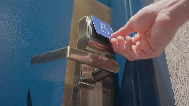 Person using electronic keycard for opening door at modern hotel. Close up of hands entering private room with security code. using electronic keycard at sensor control security system. smart home