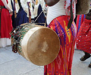 Man playing the drum and wearing one of the traditional costume of Kenya, Africa