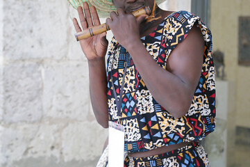 Men playing a flute and wearing one of the traditional costume of Kenya, Africa. © Raquel Pedrosa