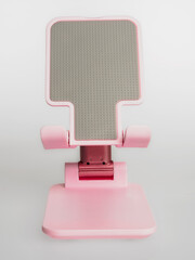 A stand for a smartphone on a white background, a stylish and convenient accessory for work and...