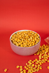 Corcflakes or Marning or marneng is traditional snack from indonesia. Made from corn kernels that fried. Fried corn in bowl with isolated background