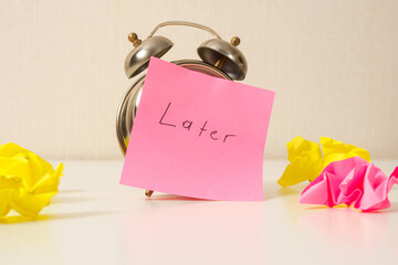 Clock with sticker “Then later”: a symbol of procrastination, a reminder that sometimes you...
