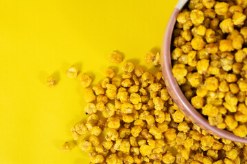 Corcflakes or Marning or marneng is traditional snack from indonesia. Made from corn kernels that fried. Fried corn in bowl with isolated background