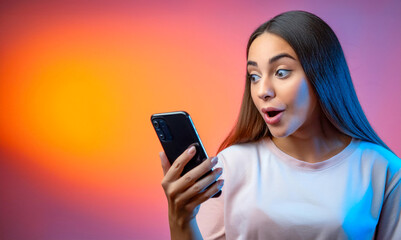 Young girl surprised and excited about the message on her smartphone
