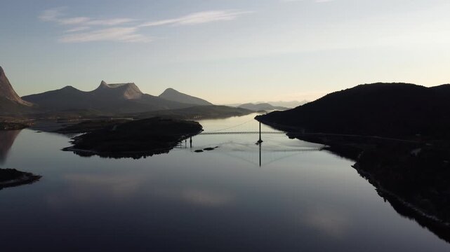 Mountain peaks by the fjords in Nordland, Norway with reflection the water surface