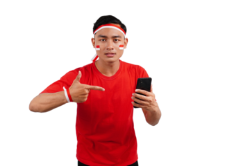 An Indonesian man celebrating Indonesia's independence day on 17 August while holding smartphone with blank screen and pointing isolated transparent