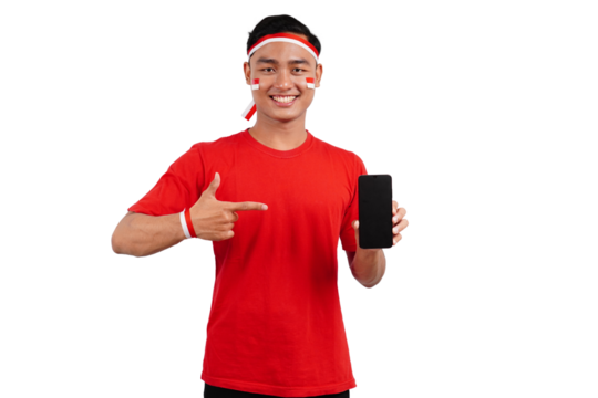 An Indonesian man celebrating Indonesia's independence day on 17 August while holding smartphone with blank screen and pointing isolated transparent