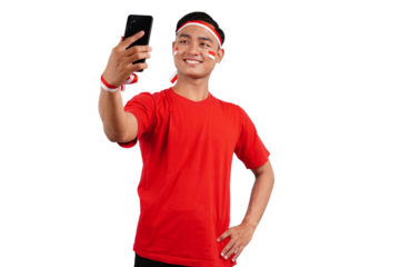 An Indonesian man celebrating Indonesia's independence day on 17 August while holding smartphone with blank screen isolated transparent