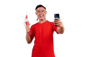 An Indonesian man celebrating Indonesia's independence day on 17 August while holding smartphone with blank screen and indonesian flag isolated transparent