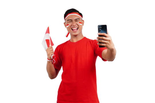 An Indonesian man celebrating Indonesia's independence day on 17 August while holding smartphone with blank screen and indonesian flag isolated transparent