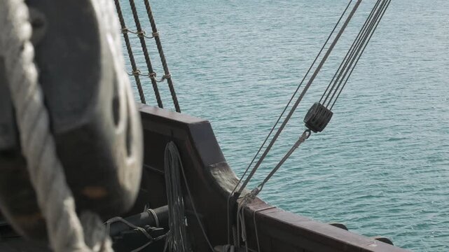 18th century wooden sailing ship deck shot and balustrade overlooking the Mediterranean Sea.