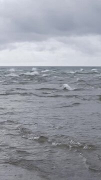 Sandbar spit at Skagen Odde called Grenen - a famous place where North and Baltic seas meet each other in a confluence. Junction between two seas in a rainy and cloudy weather.