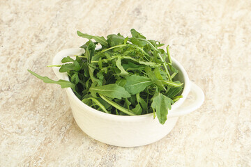 Fresh green arugula in the bowl