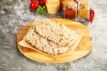 Breaded raw breaded meat schnitzel