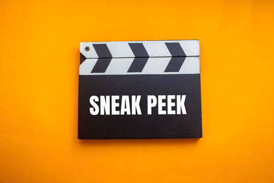 Sneak peek message written on movie clapper board with orange background. Conceptual sneak peek symbol. Copy space.