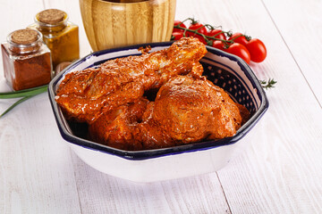 Raw turkey shoulder wing in Indian tandoori marinade