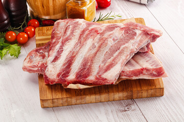 Raw pork ribs over board