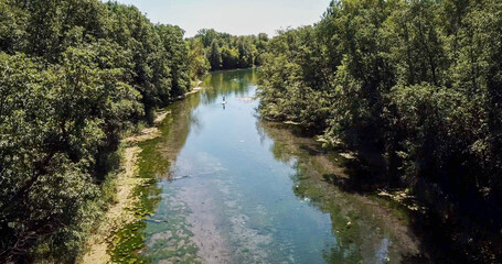 karst blue lake in the forest and SUP boards