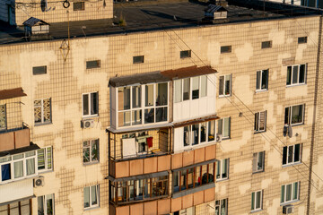 Fototapeta premium close-up street ancient houses a old windows and balconies Soviet architecture pastel colors of painted houses architectural stucco