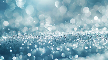 A snowy abstract background with a glitter effect, featuring shimmering snowflakes scattered across a pale blue surface. The sparkling design adds a touch of magic.