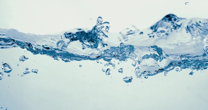 Many bubbles in water close up, abstract water wave with bubbles in slow motion