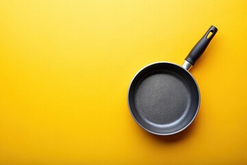 A frying pan isolated on a bright yellow background, symmetrical, breakfast, lunch, cookware, domestic, sizzling, utensil, nonstick, heat, frying pan, reflection, skillet, vibrant, chef