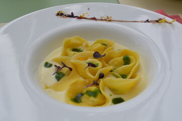 Stuffed pasta dish, tortellini, ravioli, served in a creamy sauce.