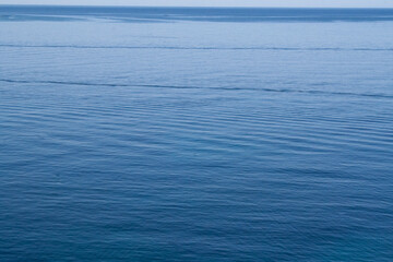 Blue seascape background. Calm sea after sunset time for publication, design, poster, calendar, post, screensaver, wallpaper, postcard, banner, cover, website. High quality photo