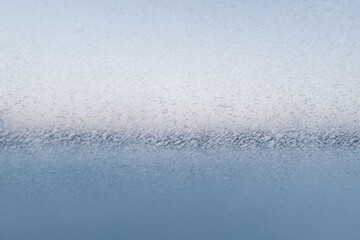 Ice patterns on glass window, selective focus. Frost background from the ice crystals for...