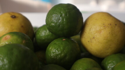 Natural fresh lime and sliced, green leaf isolated on white background