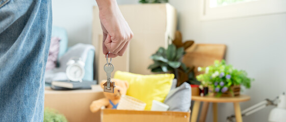 Moving house, relocation. Woman hold key house keychain in new apartment. move in new home. Buy or rent real estate. flat tenancy, leasehold property, new landlord, dwelling, loan, mortgage.