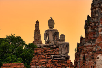 Phra Nakhon Si Ayutthaya District, Wat Chaiwatthanaram, Thailand, July 07, 2024, Ancient Buddhas at Sunset in Ayutthaya.