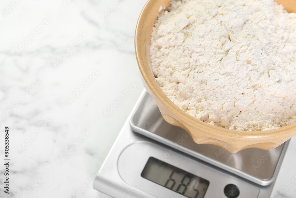 Poster Kitchen scale with bowl of flour on white marble table, above view. Space for text