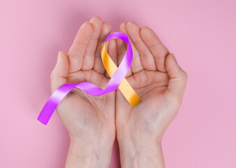 World Psoriasis Day. Woman with orange and orchid ribbon as symbol of support on pink background, top view