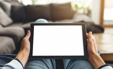 A person holding a blank tablet screen on their lap, ready for customization and usage.