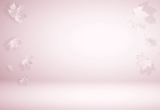 Autumn leaves in air on pastel background, toned in pink color. Space for design