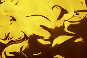 Fototapeta premium Texture of gold fluid as background, closeup