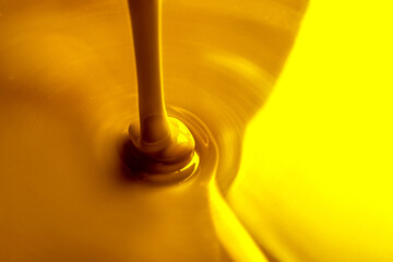 Pouring gold fluid as background, closeup view