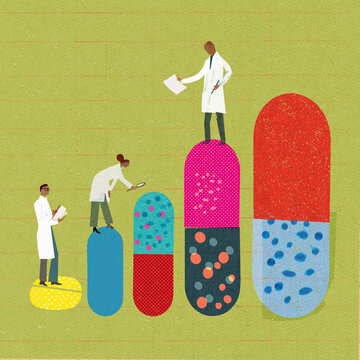 Scientists examining row of pills