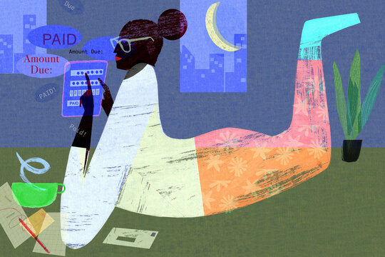Woman paying bills online at night