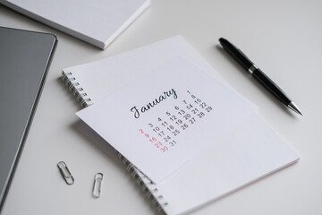 January calendar page on office desk