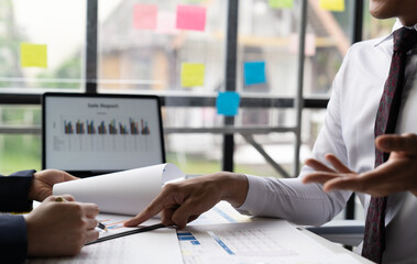 Businessman and woman discussing commercial real estate sector faces risks as financial buy used...