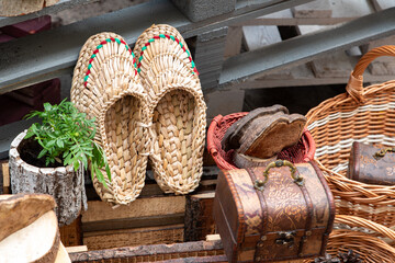 Woven bast shoes at the flea market. Handmade work