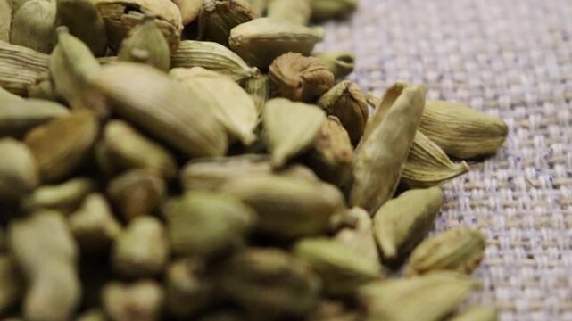 Dried cardamom seed pods  close up. Rotation 4k. Selective focus. Indian spices. 