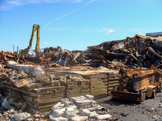 Fototapeta premium Burnt remains of an industrial site after a fire, with debris and damaged structures