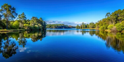 Obraz premium Clear blue sky above a tranquil lake surrounded by trees , nature, landscape, peaceful, serene, reflection, water, scenery