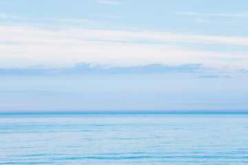 The blue calm water of Lake Michigan disappears into the clouds off the shore of Point Beach State Forest, Two Rivers, Wisconsin in early May